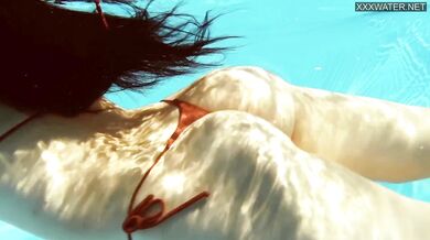 Perfect body brunette enjoys naked swimming