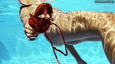 Perfect body brunette enjoys naked swimming