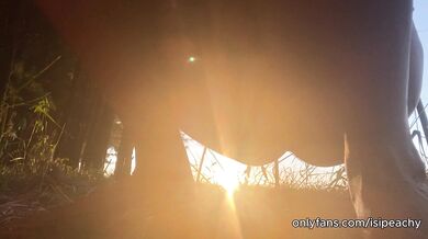 girl peeing with the sunset in the field