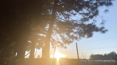 girl peeing with the sunset in the field