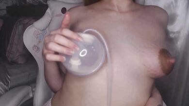 Redhead mommy extracts milk from her hard nipples
