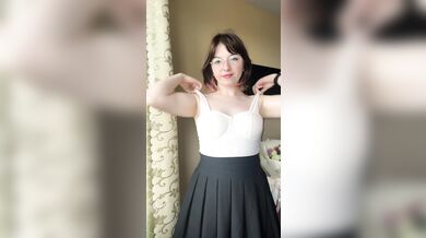 Pretty blonde in a skirt takes off her bra