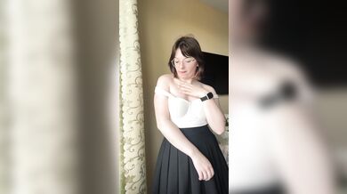 Pretty blonde in a skirt takes off her bra