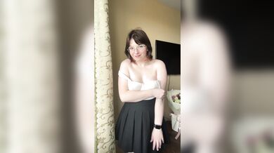 Pretty blonde in a skirt takes off her bra