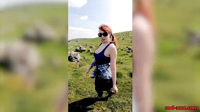 Busty redhead mature shows off her big boobs while out on a hike