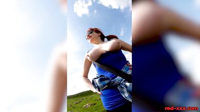Busty redhead mature shows off her big boobs while out on a hike