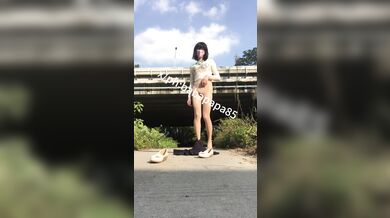 sissy in red bottom high heels and white hollow top exposes herself and pees under highway bridge