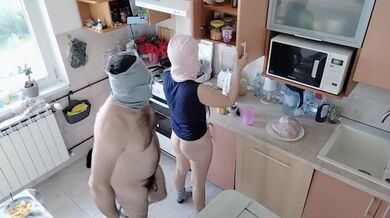Amateur couple having fun in the kitchen.