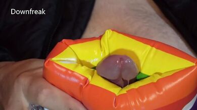 Down Jacket Wearing Fetish Guy Pleasures Himself With Inflatable Water Wing on Bed of Air Mattresses