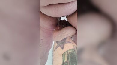 Submissive pisses on owners hand.