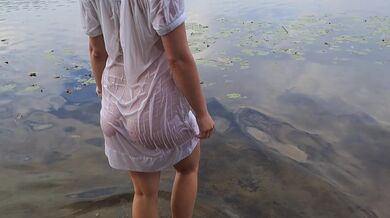 Tender girl. Nymph walks in a wet transparent shirt