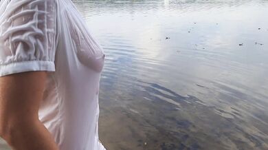 Tender girl. Nymph walks in a wet transparent shirt