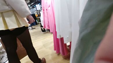 A girl walks in a short skirt without panties in a shopping mall