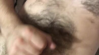 Horny hairy guy jerks his dick and moans with pleasure