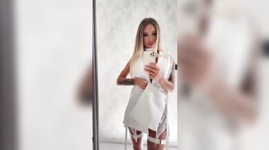 Monika Fox In White Posing In Front Of A Mirror Before Shooting