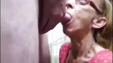 wrinkled face granny with glasses sucking cock to drink cum