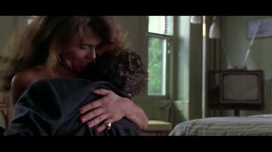 Brunette Lena Olin in lingerie shows off her small boobs