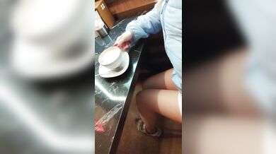 Risky beauty shows sweet pussy in café