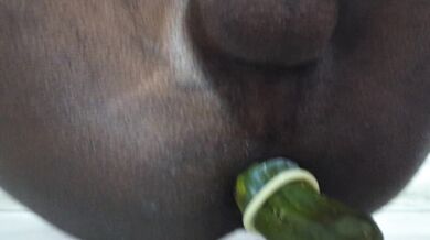 Putting a cucumber in the ass while jerking off with a condom