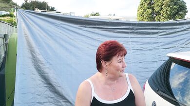 Trashy MILF slut pisses on the grass in front of other campers at the beach