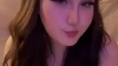 Busty babe plays with her tits