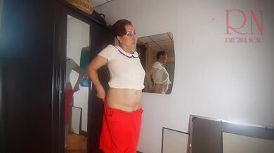 A naked lady does make-up in front of a mirror, puts on underwear, stockings, a skirt. 3