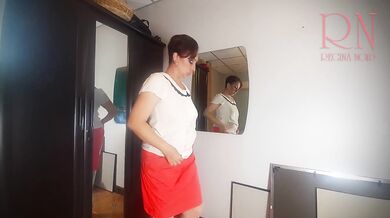 A naked lady does make-up in front of a mirror, puts on underwear, stockings, a skirt. 3