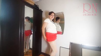 A naked lady does make-up in front of a mirror, puts on underwear, stockings, a skirt. 3