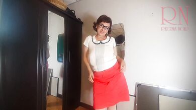 A naked lady does make-up in front of a mirror, puts on underwear, stockings, a skirt. 3