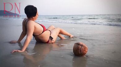 Nice lady at lonely nudist beach. Red swimsuit. Red bikini. Coconut