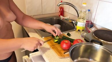 Cali is cooking topless in the kitchen