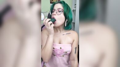 Green haired girl makes it all disappear inside her mouth