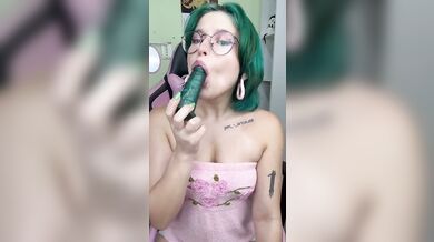 Green haired girl makes it all disappear inside her mouth