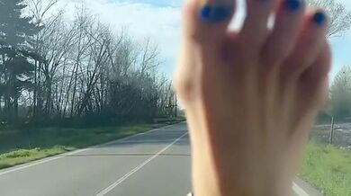 Hot blonde milf plays with her toes while driving a car