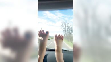 Hot blonde milf plays with her toes while driving a car