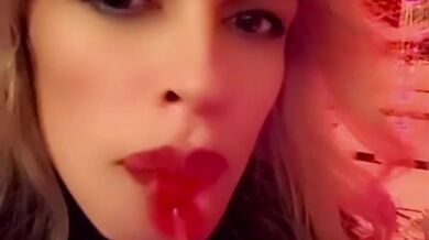 Hot blonde milf sexily sucks a lollipop in front of everyone in a cafe