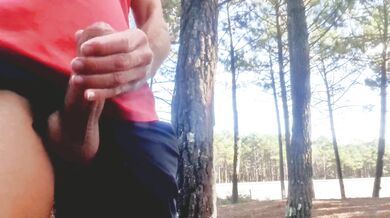 Sexy guy jacking off in public near the road.