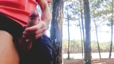 Sexy guy jacking off in public near the road.