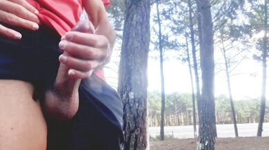 Sexy guy jacking off in public near the road.