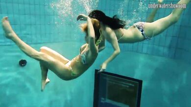 Girls Andrea and Monica stripping one another underwater