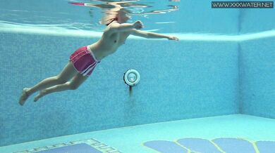 Cute petite teen wearing cute clothes underwater