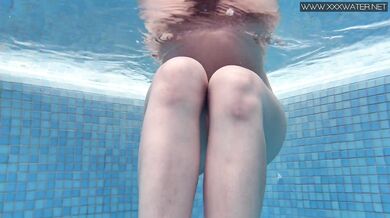 Cute petite teen wearing cute clothes underwater