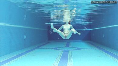 Cute petite teen wearing cute clothes underwater