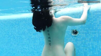 Cute petite teen wearing cute clothes underwater