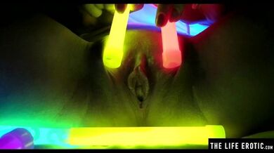 Watch this hot blonde plunge glowsticks in her pussy and ass