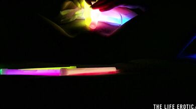 Watch this hot blonde plunge glowsticks in her pussy and ass