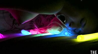 Watch this hot blonde plunge glowsticks in her pussy and ass
