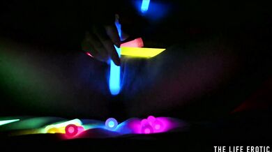 Watch this hot blonde plunge glowsticks in her pussy and ass