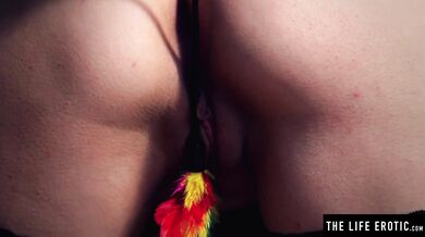 Horny girl tickling her bare pussy with feathers and fingers