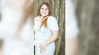 a redheaded hottie in an arousing blue dress.